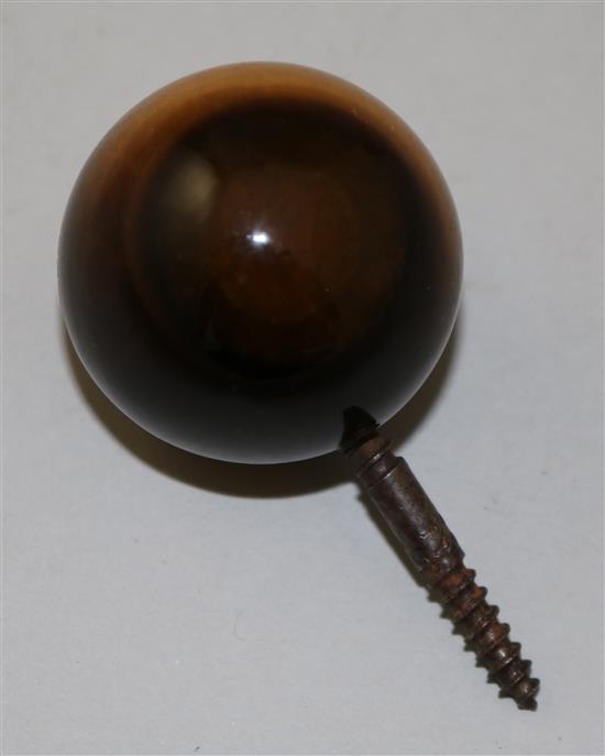 An early 20th century tigers eye quartz cane handle carved with the face of an owl, diameter 1.75in.